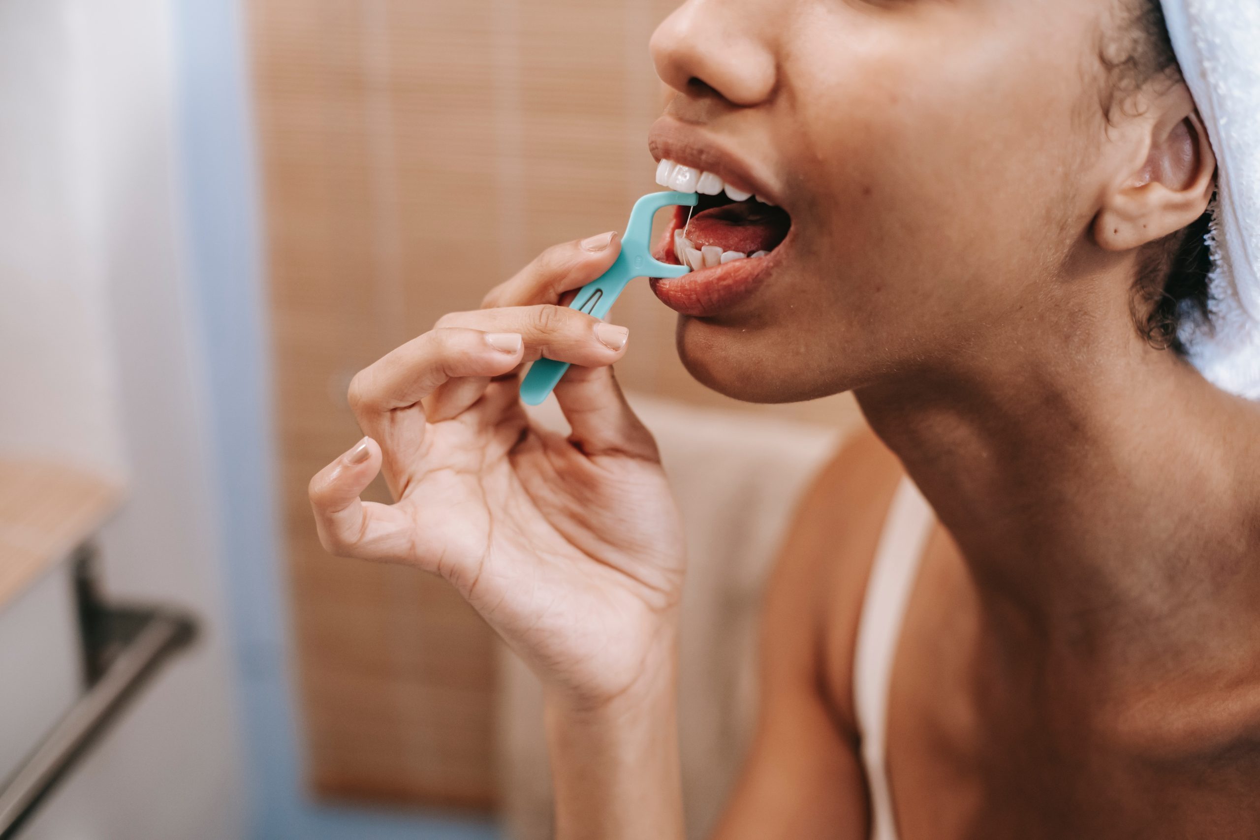 woman using flosser to clean teeth